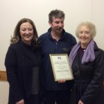 Photograph of Rita Clarke receiving certificate.